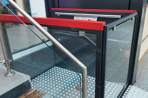 An image of an accessibility elevator outside a business